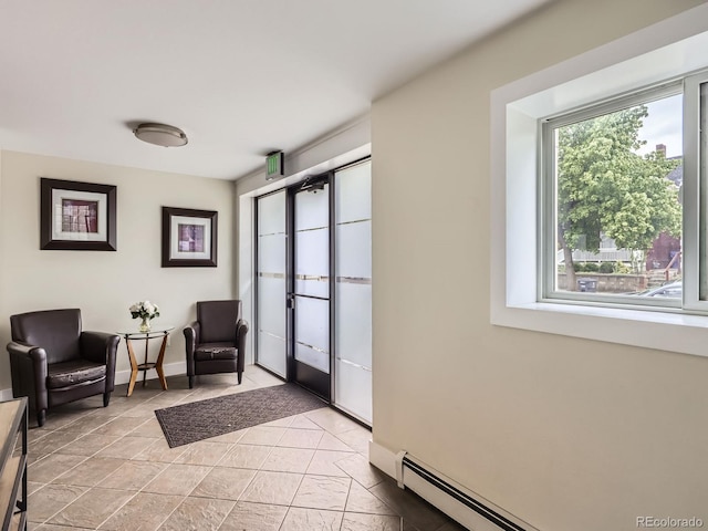2460 W Caithness Pl Unit 105, Denver, CO 80211 - entryway with a baseboard radiator and baseboards