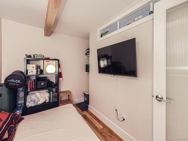 2460 W Caithness Pl Unit 105, Denver, CO 80211 - bedroom featuring light wood finished floors, beamed ceiling, and baseboards