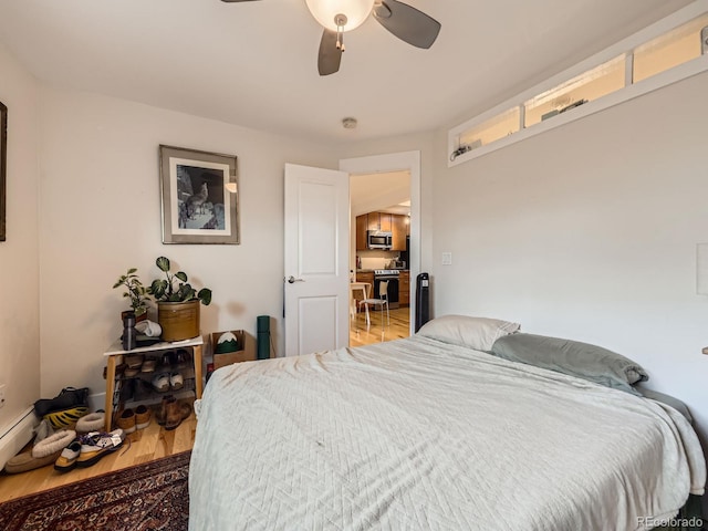 2460 W Caithness Pl Unit 105, Denver, CO 80211 - bedroom featuring wood finished floors and a ceiling fan