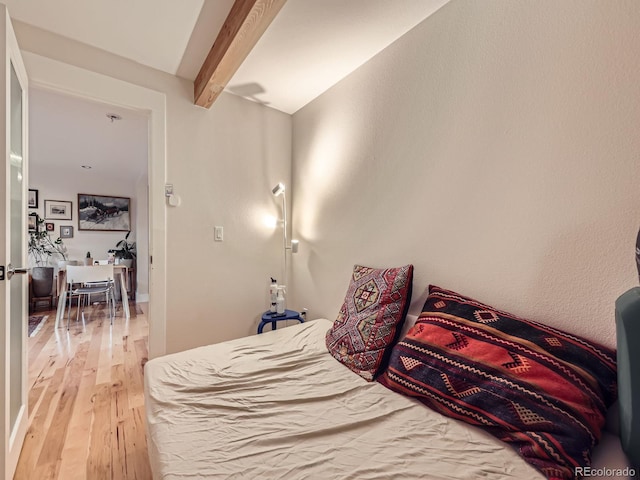 2460 W Caithness Pl Unit 105, Denver, CO 80211 - bedroom featuring beamed ceiling and light wood-type flooring