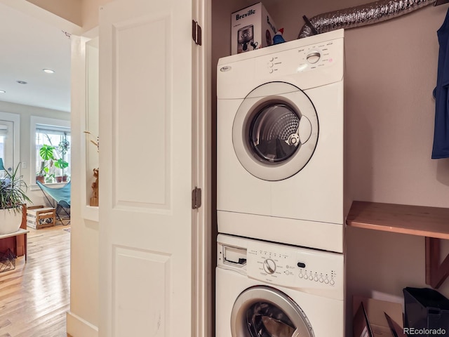 2460 W Caithness Pl Unit 105, Denver, CO 80211 - clothes washing area featuring stacked washer / drying machine, light wood-style floors, and recessed lighting