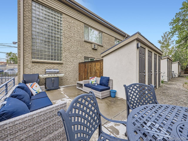 2460 W Caithness Pl Unit 105, Denver, CO 80211 - view of patio / terrace with grilling area, outdoor lounge area, fence, and an outdoor structure