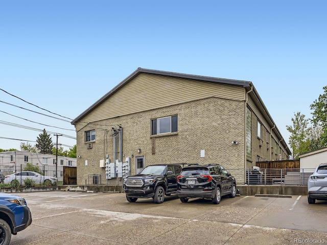 2460 W Caithness Pl Unit 105, Denver, CO 80211 - uncovered parking lot featuring fence