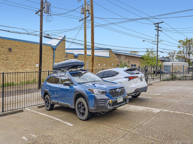 2460 W Caithness Pl Unit 105, Denver, CO 80211 - uncovered parking lot featuring fence