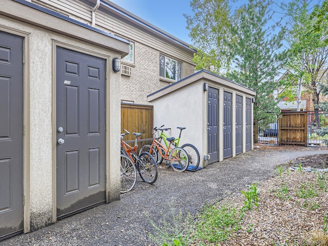 2460 W Caithness Pl Unit 105, Denver, CO 80211 - property entrance featuring fence and stucco siding