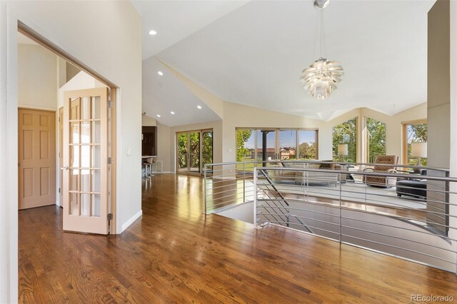 15132 Pecos St, Broomfield, CO 80023 - unfurnished living room featuring a chandelier, wood finished floors, plenty of natural light, recessed lighting, and high vaulted ceiling