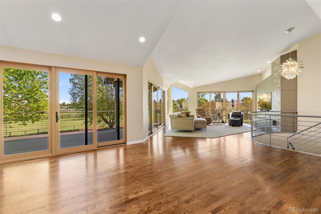 15132 Pecos St, Broomfield, CO 80023 - living area with lofted ceiling, plenty of natural light, wood finished floors, and recessed lighting