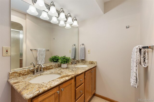 15132 Pecos St, Broomfield, CO 80023 - bathroom with double vanity, a shower with door, and baseboards