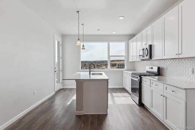453 Interlocken Blvd Unit 101, Broomfield, CO 80021 - kitchen with stainless steel appliances, dark wood-type flooring, backsplash, a sink, and an island with sink