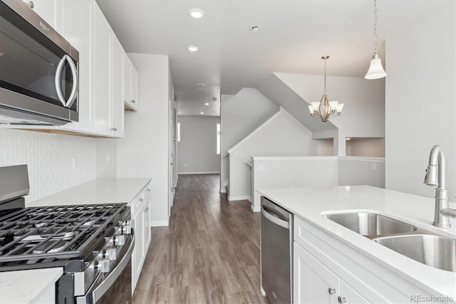 453 Interlocken Blvd Unit 101, Broomfield, CO 80021 - kitchen featuring decorative backsplash, stainless steel appliances, white cabinetry, a sink, and light stone counters
