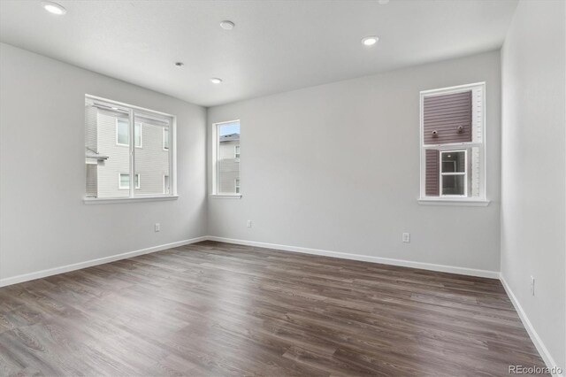 453 Interlocken Blvd Unit 101, Broomfield, CO 80021 - empty room featuring baseboards, recessed lighting, and dark wood-type flooring