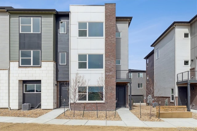 453 Interlocken Blvd Unit 101, Broomfield, CO 80021 - view of property featuring central air condition unit and brick siding