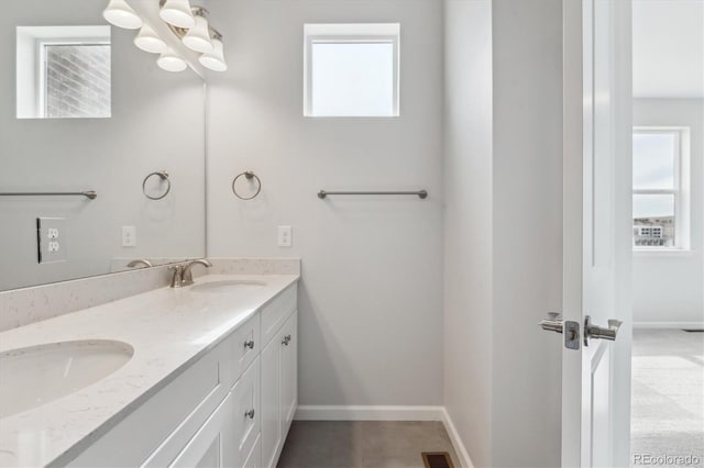 453 Interlocken Blvd Unit 101, Broomfield, CO 80021 - bathroom with baseboards, double vanity, and a sink