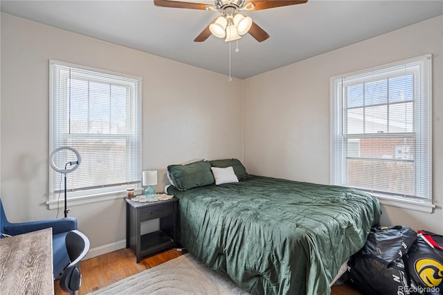2041 7th Ave, Greeley, CO 80631 - bedroom featuring wood finished floors, multiple windows, and a ceiling fan