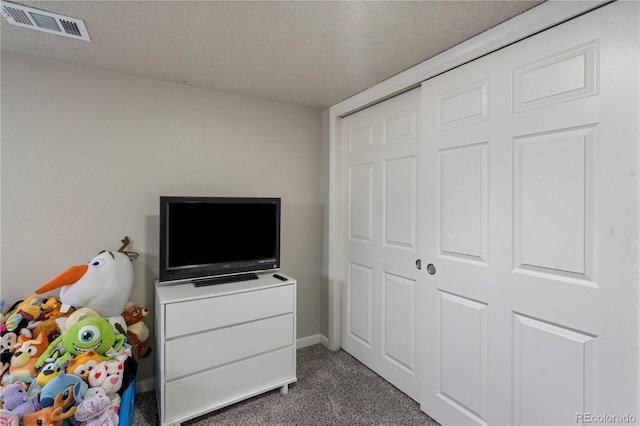 2041 7th Ave, Greeley, CO 80631 - bedroom with dark colored carpet, a textured ceiling, and a closet