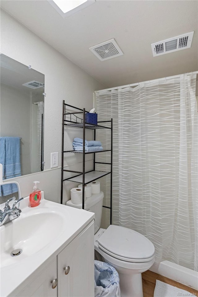 2041 7th Ave, Greeley, CO 80631 - full bathroom with vanity, wood finished floors, and a shower with curtain