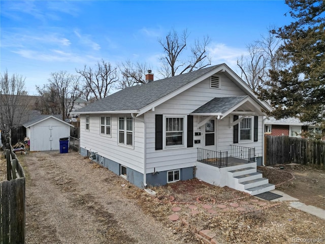2041 7th Ave, Greeley, CO 80631 - view of front of home featuring roof with shingles, a storage unit, and a chimney