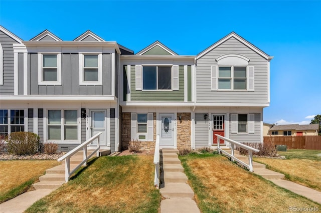 4160 Baytown Dr, Colorado Springs, CO 80916 - view of property featuring fence, a front yard, and stone siding