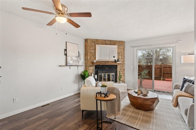 4160 Baytown Dr, Colorado Springs, CO 80916 - living area featuring a textured ceiling, ceiling fan, visible vents, a fireplace, and wood finished floors