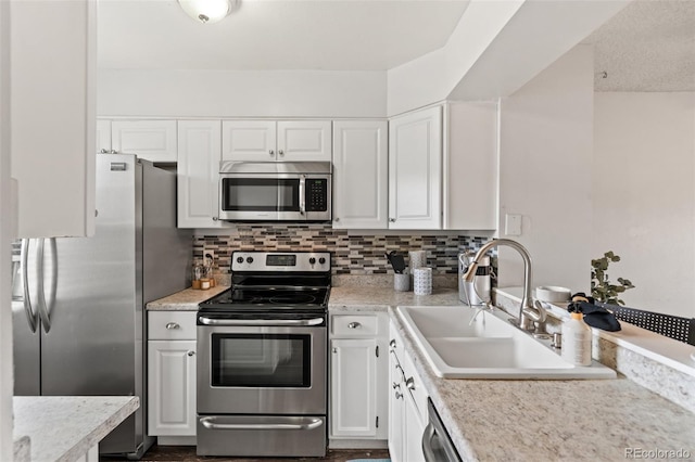 4160 Baytown Dr, Colorado Springs, CO 80916 - kitchen with white cabinetry, backsplash, a sink, and stainless steel appliances