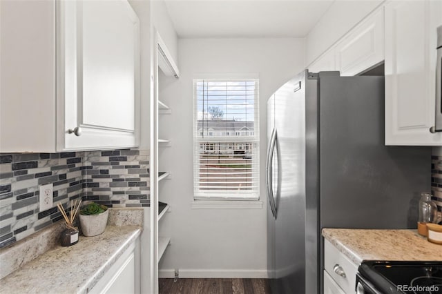 4160 Baytown Dr, Colorado Springs, CO 80916 - kitchen with white cabinetry, tasteful backsplash, baseboards, and wood finished floors