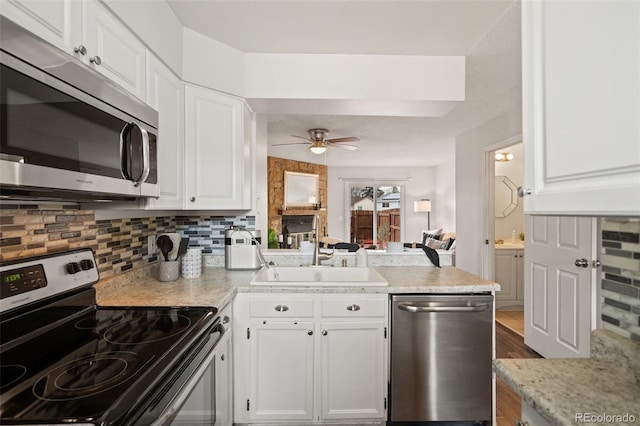 4160 Baytown Dr, Colorado Springs, CO 80916 - kitchen with a sink, white cabinetry, a peninsula, stainless steel appliances, and ceiling fan