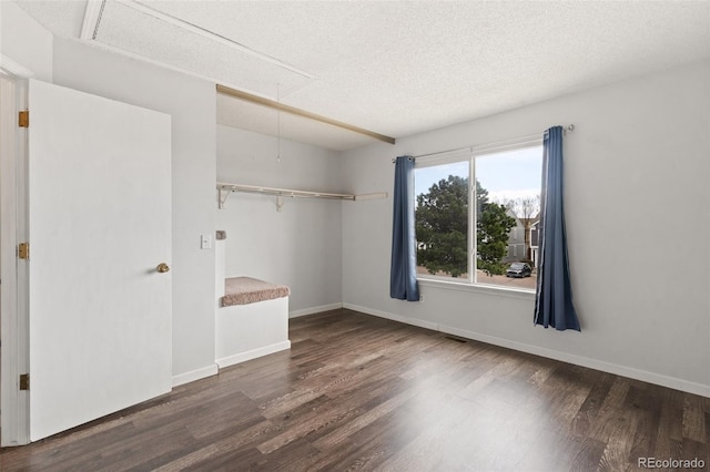 4160 Baytown Dr, Colorado Springs, CO 80916 - unfurnished bedroom featuring attic access, baseboards, a textured ceiling, visible vents, and wood finished floors