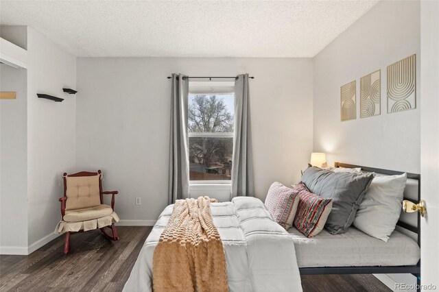 4160 Baytown Dr, Colorado Springs, CO 80916 - bedroom with baseboards, a textured ceiling, and wood finished floors