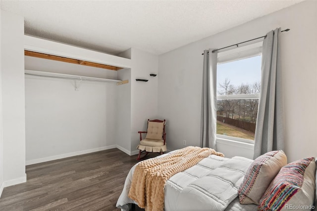 4160 Baytown Dr, Colorado Springs, CO 80916 - bedroom featuring a closet, a textured ceiling, baseboards, and wood finished floors