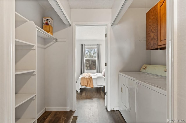 4160 Baytown Dr, Colorado Springs, CO 80916 - clothes washing area with washer and clothes dryer, dark wood-style floors, baseboards, visible vents, and cabinet space