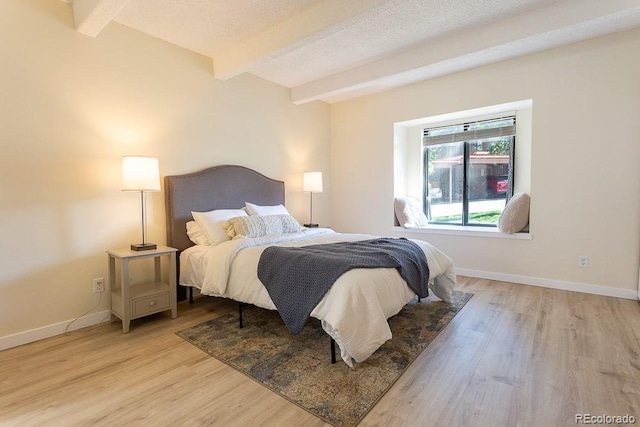 2525 S Dayton Way Unit 1201, Denver, CO 80231 - bedroom with beamed ceiling and light wood finished floors