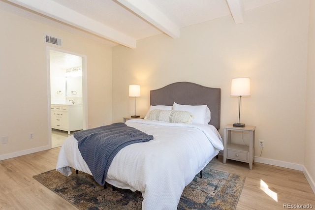 2525 S Dayton Way Unit 1201, Denver, CO 80231 - bedroom with beamed ceiling, light wood-type flooring, and ensuite bathroom
