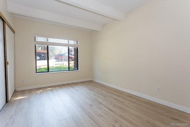 2525 S Dayton Way Unit 1201, Denver, CO 80231 - unfurnished bedroom featuring beam ceiling, wood finished floors, and a closet