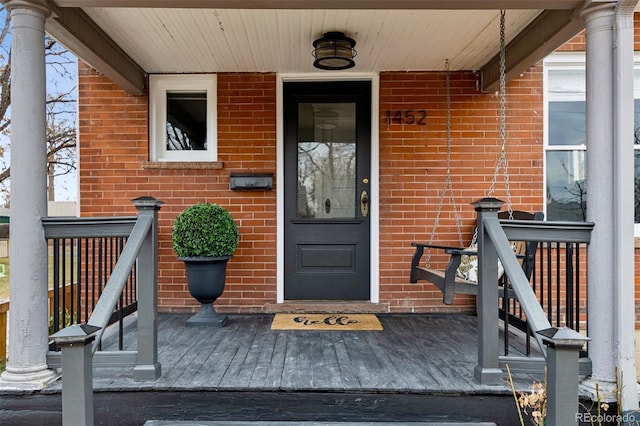 entrance to property featuring a porch