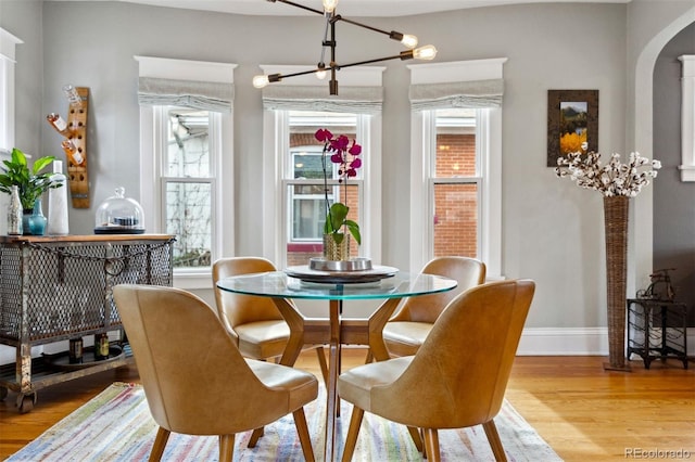 dining room featuring a notable chandelier and light hardwood / wood-style flooring