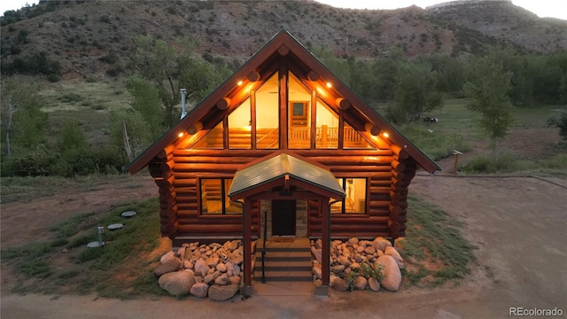 log-style house featuring log siding and a mountain view