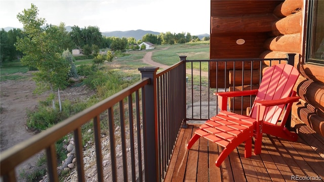 balcony featuring a rural view and a mountain view