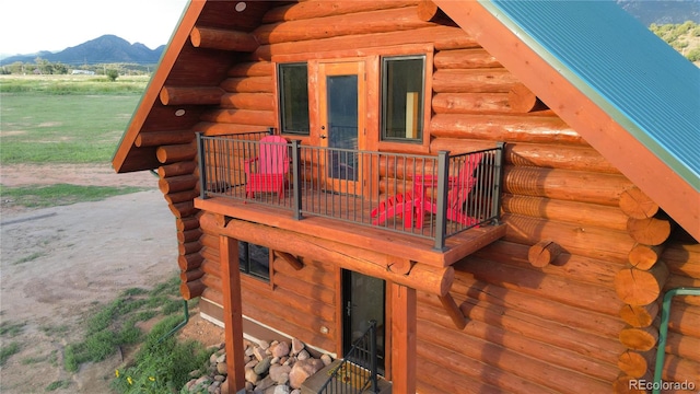 exterior space featuring a mountain view and log walls