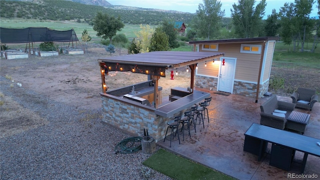 view of patio featuring an outdoor bar