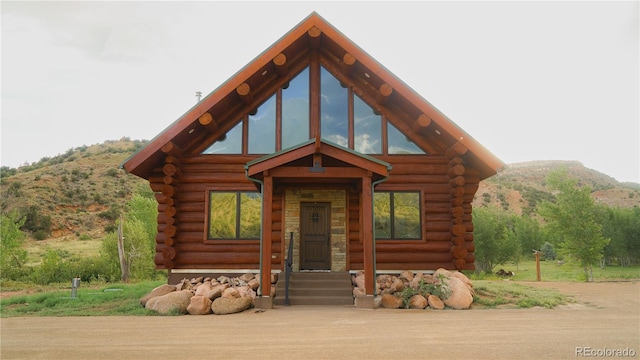 log home with a mountain view and log exterior