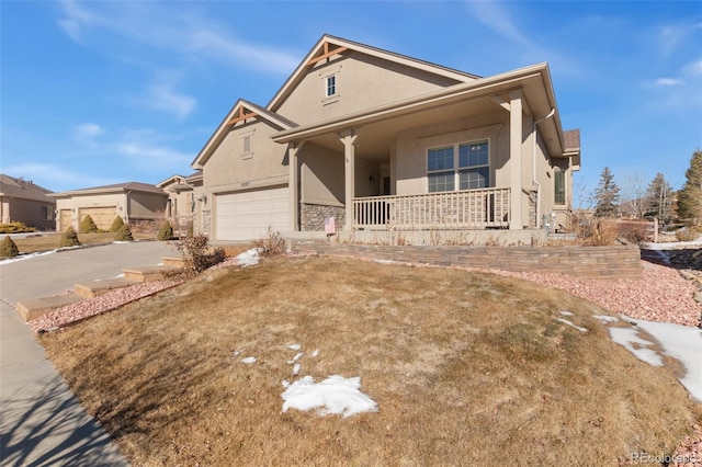 view of front of house with a garage, a front yard, and covered porch