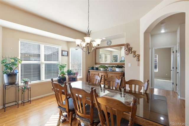 dining space featuring a chandelier and light wood-type flooring