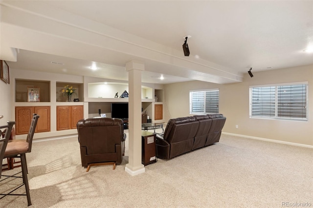 living room featuring light colored carpet and built in features