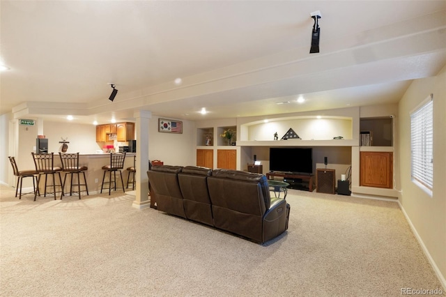 carpeted living room featuring indoor bar and built in features