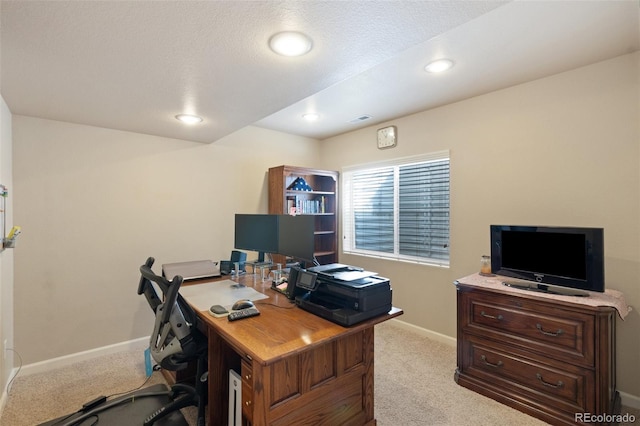 carpeted office with a textured ceiling