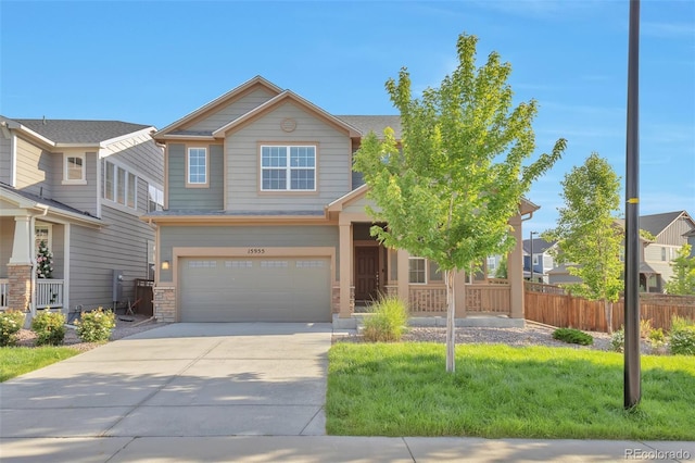 15955 E Otero Cir, Centennial, CO 80112 - view of front of house with driveway, an attached garage, and stone siding
