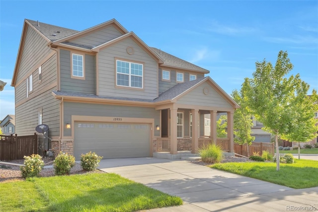 15955 E Otero Cir, Centennial, CO 80112 - craftsman inspired home featuring covered porch, a garage, driveway, stone siding, and roof with shingles