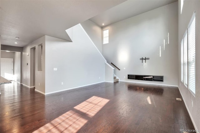 15955 E Otero Cir, Centennial, CO 80112 - unfurnished living room with stairs, dark wood-type flooring, plenty of natural light, and recessed lighting
