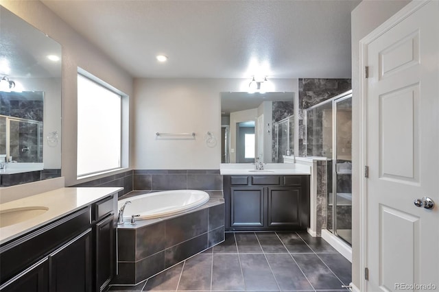 15955 E Otero Cir, Centennial, CO 80112 - full bath featuring two vanities, a stall shower, tile patterned floors, and a garden tub