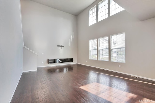 15955 E Otero Cir, Centennial, CO 80112 - unfurnished living room featuring wood-type flooring and a towering ceiling